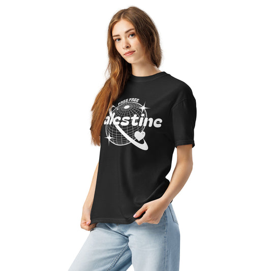 Female model wearing a Free Palestine tee, featuring a y2k type of globe with hearts and stars and the words FREE FREE PALESTINE. A heart keffiyeh and some white doves is on the right sleeve