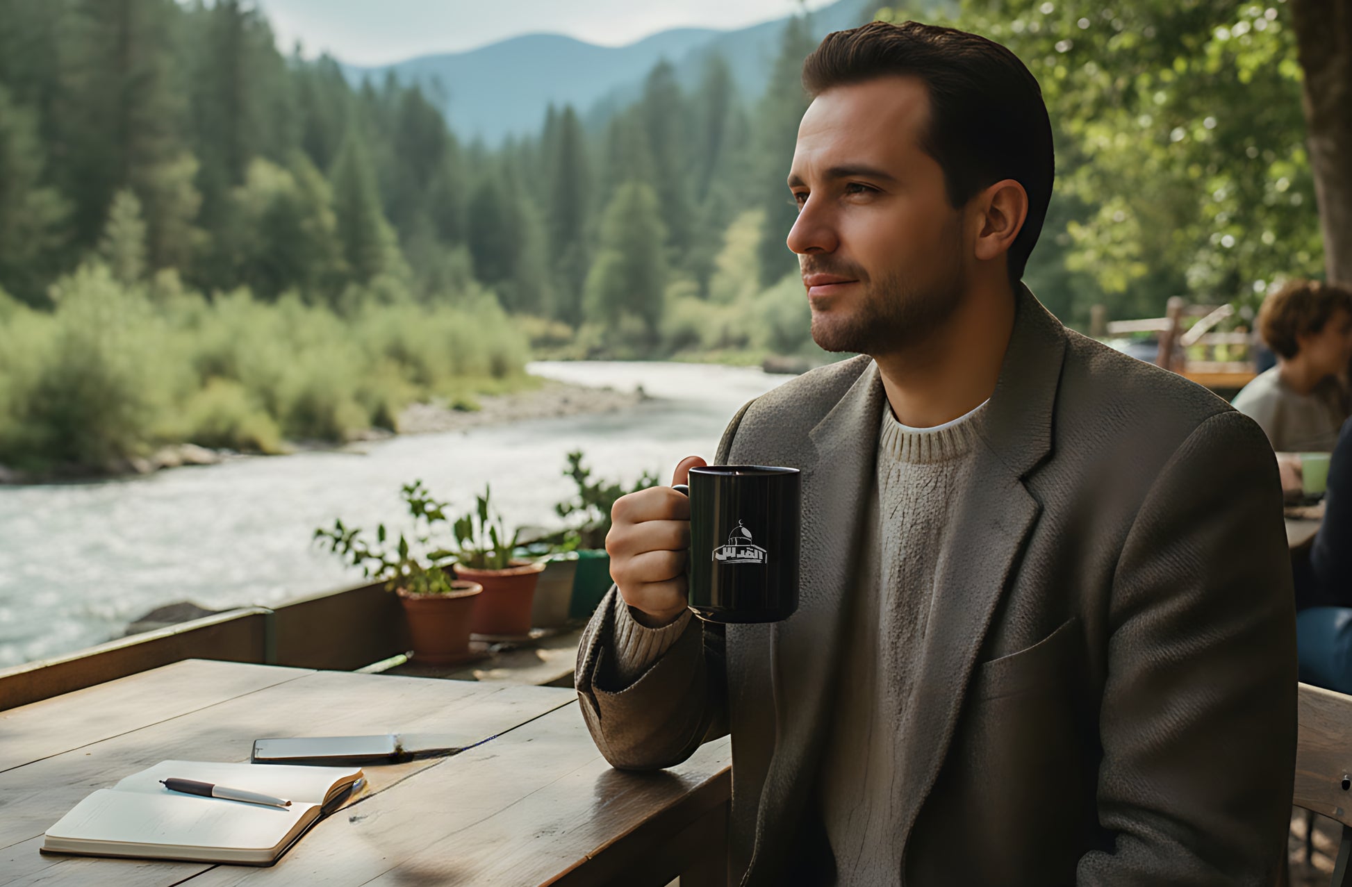 A man sitting by a river with a mug, surrounded by nature. Al Quds black mug by Warrior Ink Apparel