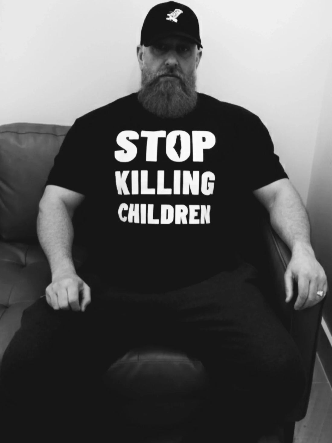 MALE MODEL WEARING THE "STOP KILLING CHILDREN" TEE