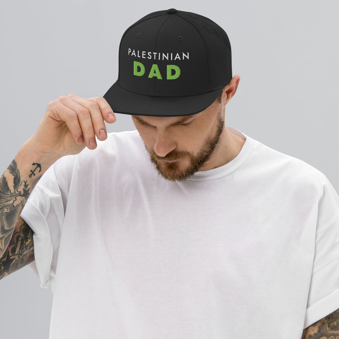 Model wearing PALESTINIAN DAD Palestine snapback cap by Warrior Ink Apparel