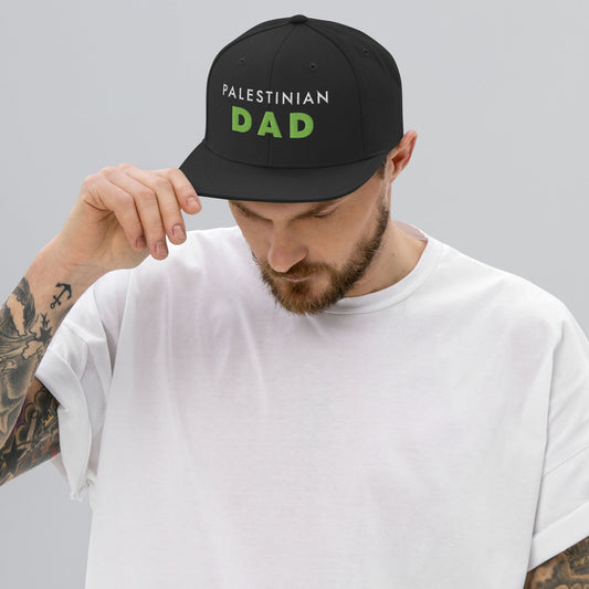 Model wearing PALESTINIAN DAD Palestine snapback cap by Warrior Ink Apparel