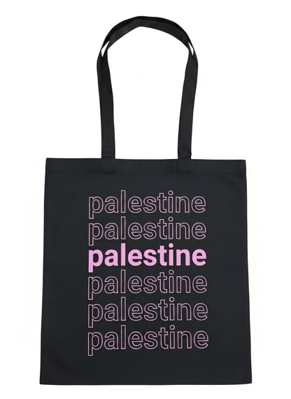 Palestine layered tote bag with stacked typography design in pink worn outdoors at sunset by Warrior Ink Apparel