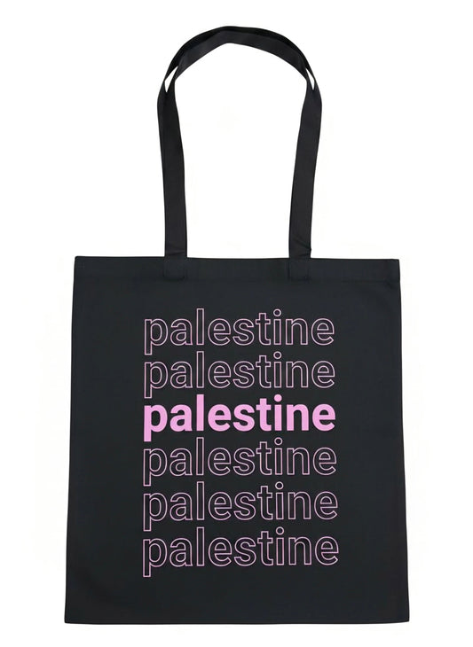 Palestine layered tote bag with stacked typography design in pink worn outdoors at sunset by Warrior Ink Apparel