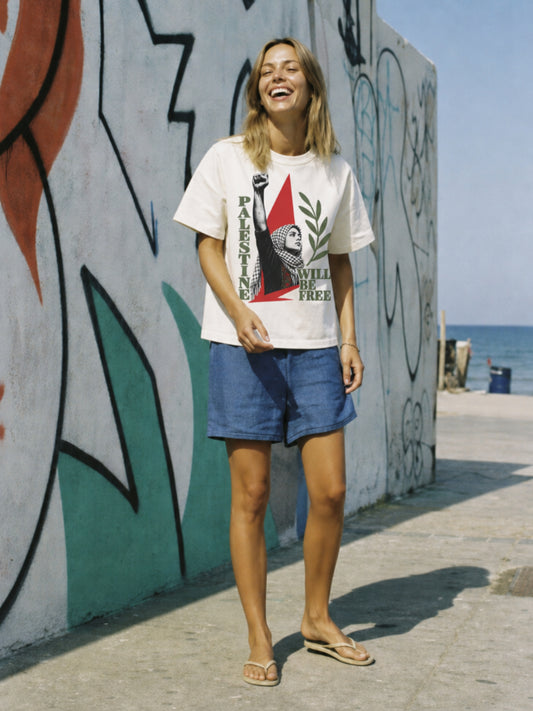 Woman wearing Palestine Will Be Free heavyweight resistance T-shirt