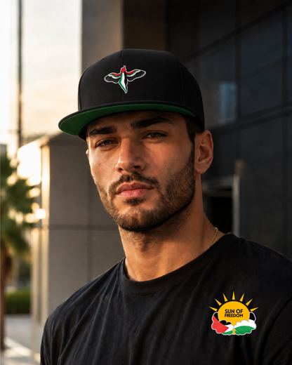 Model wearing FREEDOM WINGS Palestine flat bill cap from Warrior Ink Apparel