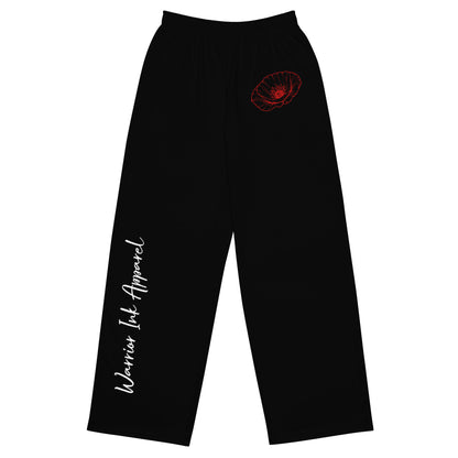 Front view of RED POPPY OF PALESTINE black wide-leg pants with red poppy detail