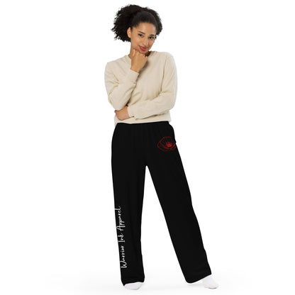 Model wearing RED POPPY OF PALESTINE wide-leg pants by Warrior Ink Apparel