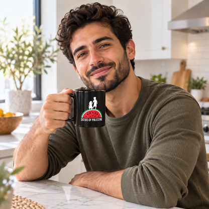 A man in an olive green long-sleeve shirt holds a black ceramic mug with a SEEDS OF PALESTINE graphic by Warrior Ink
