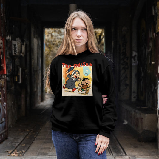 Female model wears Cartoon-style Palestinian mother chasing her son with a slipper on a black long sleeve shirt – The ShibShib design by Warrior Ink