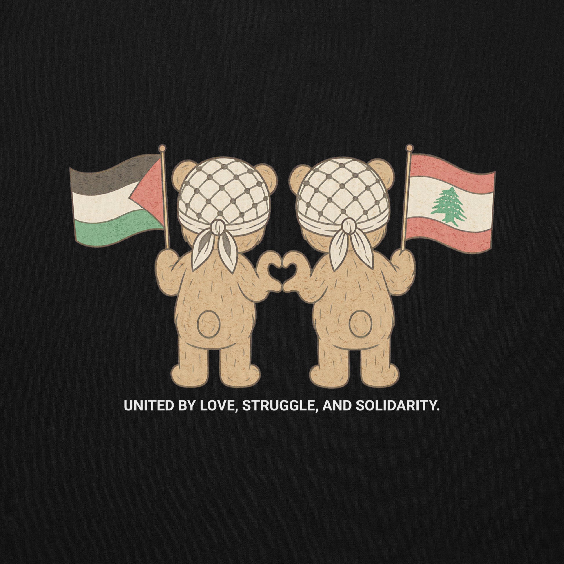 Black hoodie featuring two teddy bears wearing keffiyehs, holding Palestinian and Lebanese flags. Text below reads "United by Love, Struggle, and Solidarity."